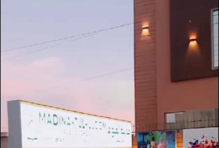 School signboard beside the campus at dusk
