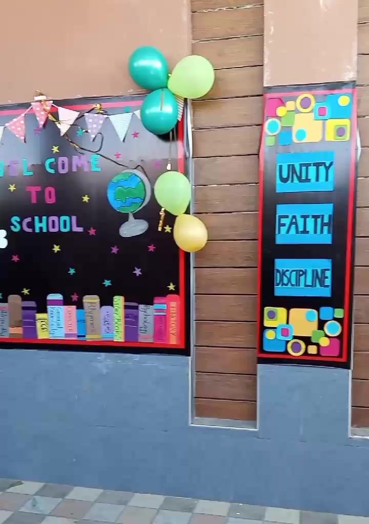School display boards reading Welcome to School and Unity, Faith, Discipline