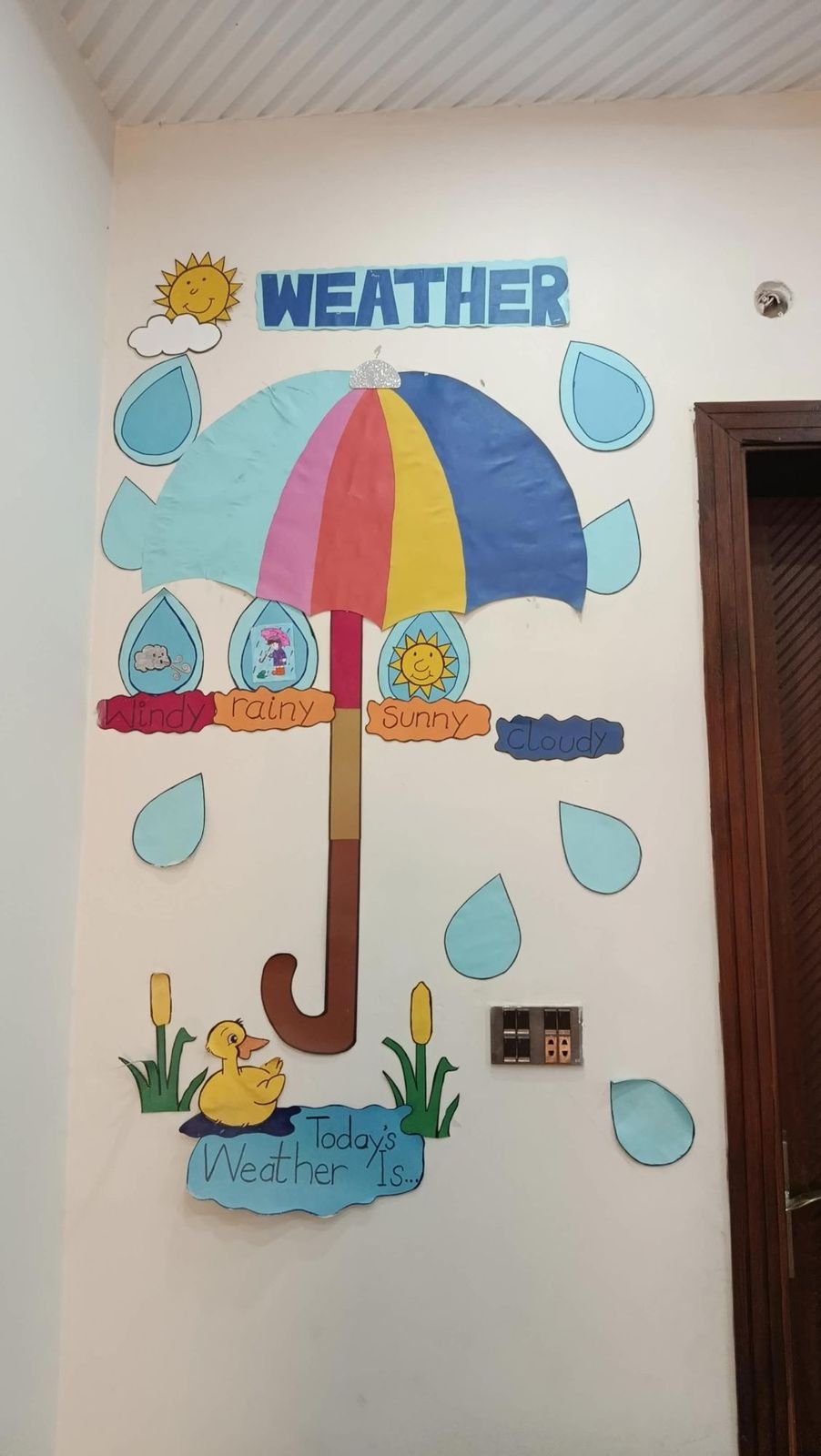 Weather learning display with a large paper umbrella